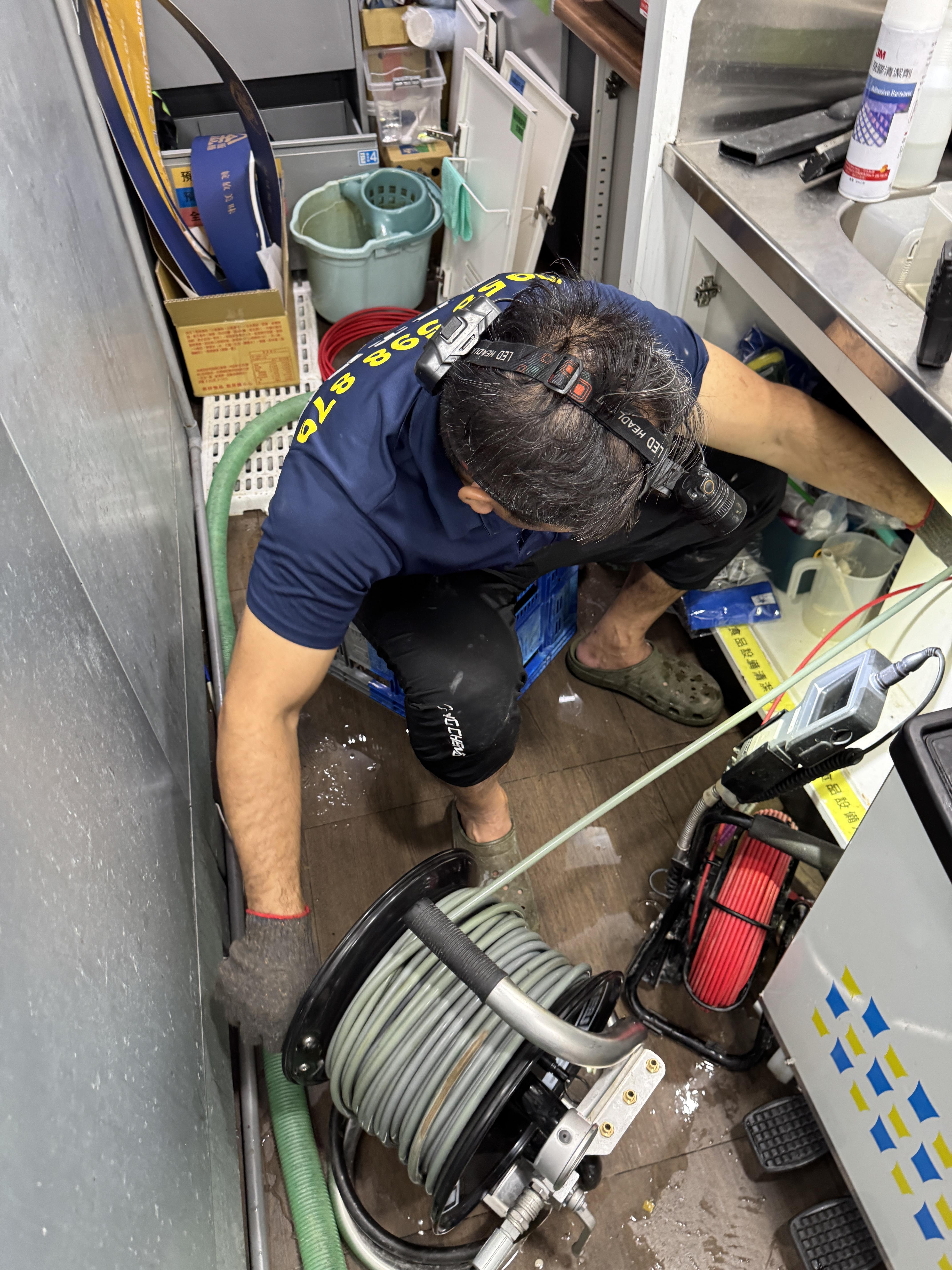 Technician inspecting FamilyMart drainage with endoscope