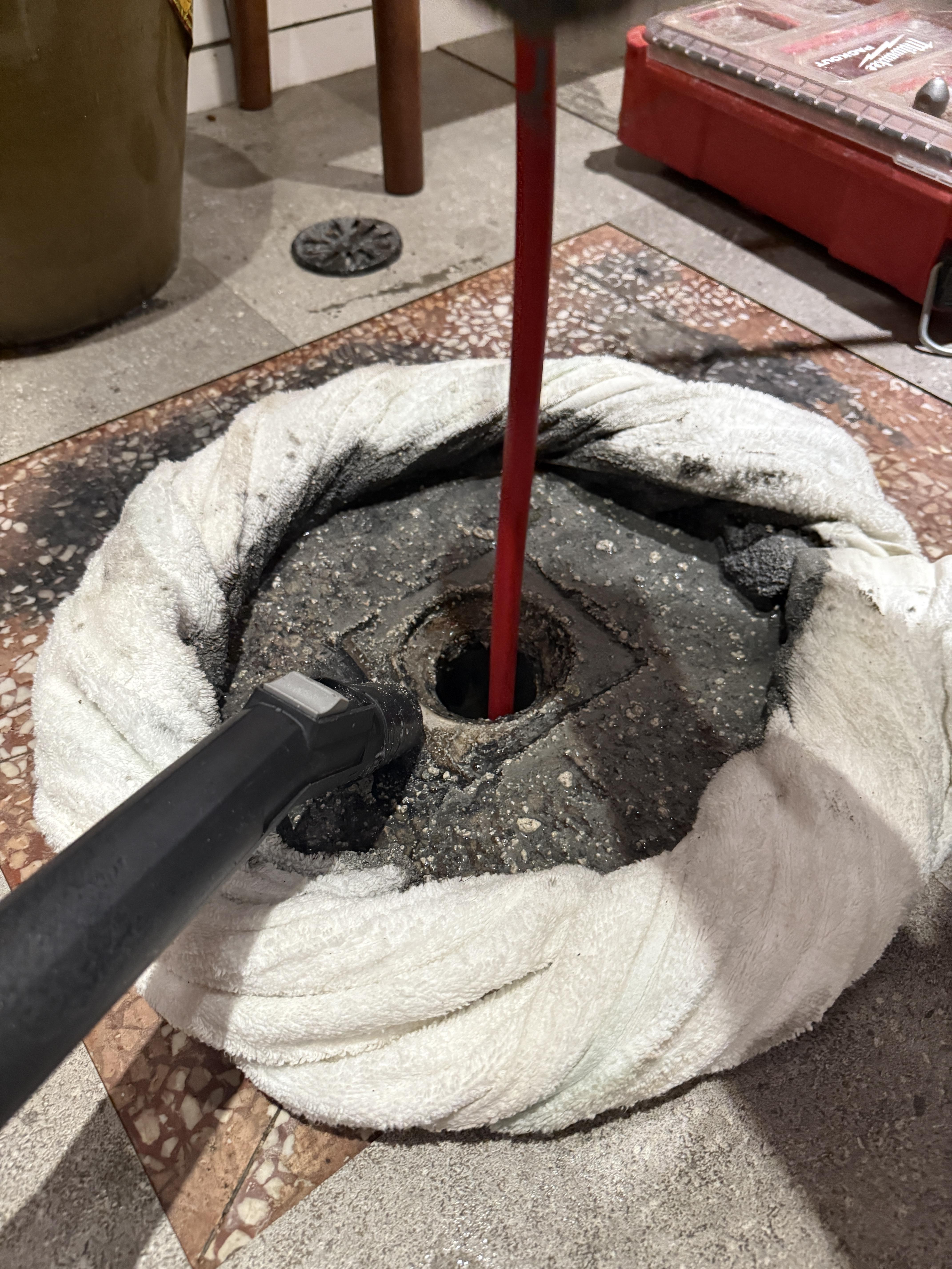 A technician from Yongzheng Engineering in Kaohsiung uses a video pipe inspection camera to show a client the actual cement blockage and pinpoint its location for hydro-jetting.