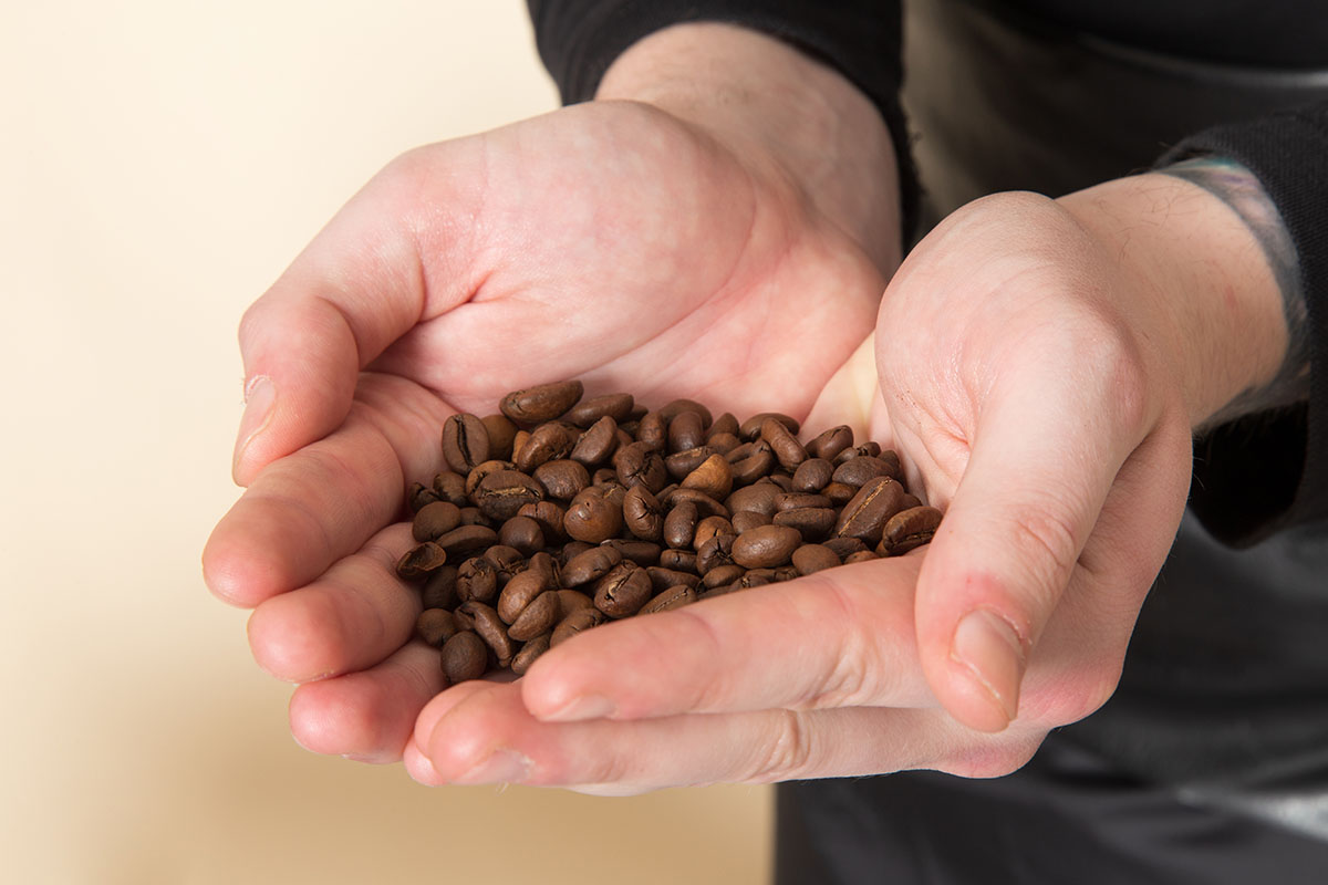 brown-coffee-seeds-baristna-holding-his-hands.jpg