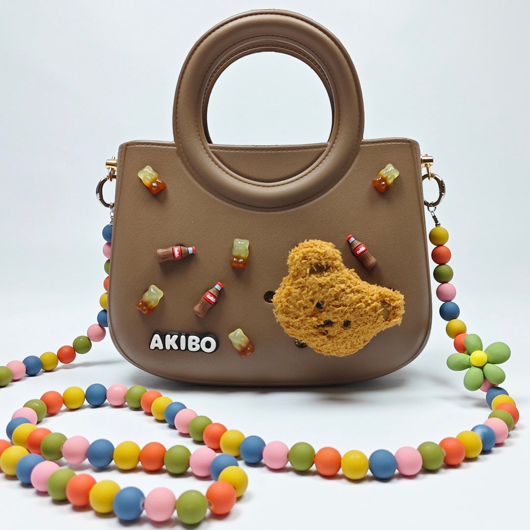 【買1送1】AKIBO滿月包-焦糖咖/童趣彩珠背帶(肩背手提洞洞包。中性款、輕量、防水) / 內附AKIBO品牌鞋扣1個。現在買再送鞋扣組(不挑款)